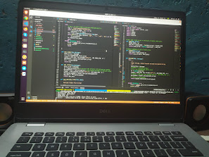 Laptop displaying code at Janak's desk
